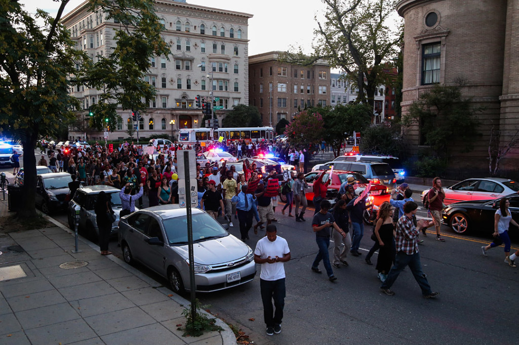 Protesters turn onto U street during the march after National Moment of Silence for Michael Brown on Thursday, August 14, 2014 in Washington D.C. Protesters held a moment of silence for Michael Brown who was shot by police in Ferguson, Missouri. Brown was unarmed and had his hands up at the time he was shot. Photo credit: Brian Nguyen