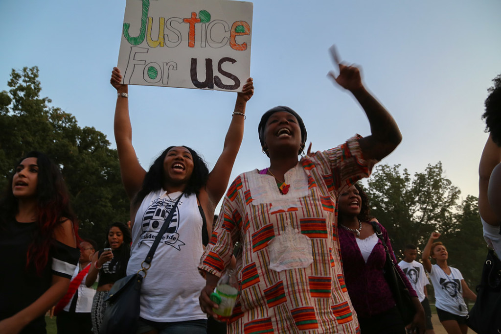 Two women march down the streets of Washington D.C. after the National Moment of Silence for Michael Brown on Thursday, August 14, 2014 in Washington D.C. Protesters held a moment of silence for Michael Brown who was shot by police in Ferguson, Missouri. Brown was unarmed and had his hands up at the time he was shot. Photo credit: Brian Nguyen