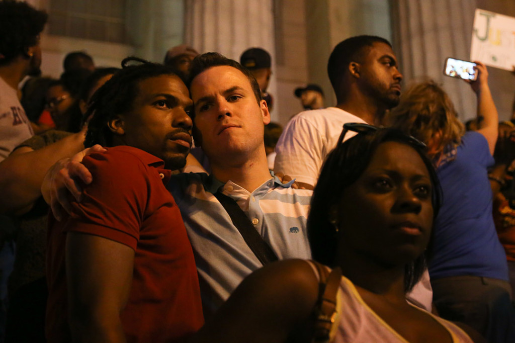 Two men embrace after the march stopped across from the Verizon center following the National Moment of Silence for Michael Brown on Thursday, August 14, 2014 in Washington D.C. Protesters held a moment of silence for Michael Brown who was shot by police in Ferguson, Missouri. Brown was unarmed and had his hands up at the time he was shot. Photo credit: Brian Nguyen