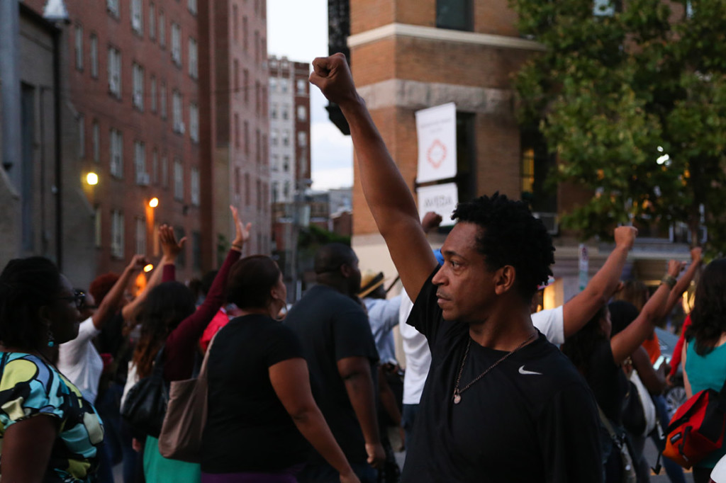 A man holds up her first during the march after National Moment of Silence for Michael Brown on Thursday, August 14, 2014 in Washington D.C. Protesters held a moment of silence for Michael Brown who was shot by police in Ferguson, Missouri. Brown was unarmed and had his hands up at the time he was shot. Photo credit: Brian Nguyen