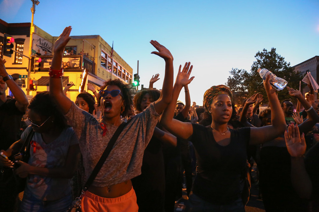 Protesters hold up their hands as they chant "hands up don't shoot" during the march held after the National Moment of Silence for Michael Brown on Thursday, August 14, 2014 in Washington D.C. Protesters held a moment of silence for Michael Brown who was shot by police in Ferguson, Missouri. Brown was unarmed and had his hands up at the time he was shot. Photo credit: Brian Nguyen