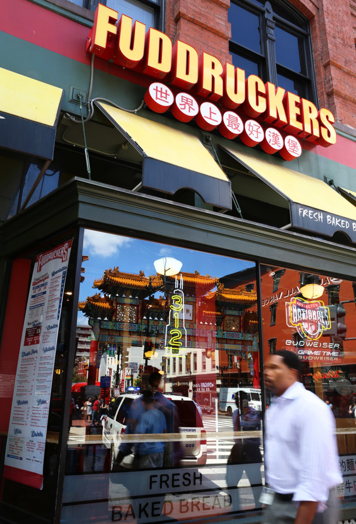 A businessman walks past Fuddruckers on Wednesday, August 13, 2014. Many businesses in Chinatown display Chinese letters due to a law (Brian Nguyen/AAJA VOICES)