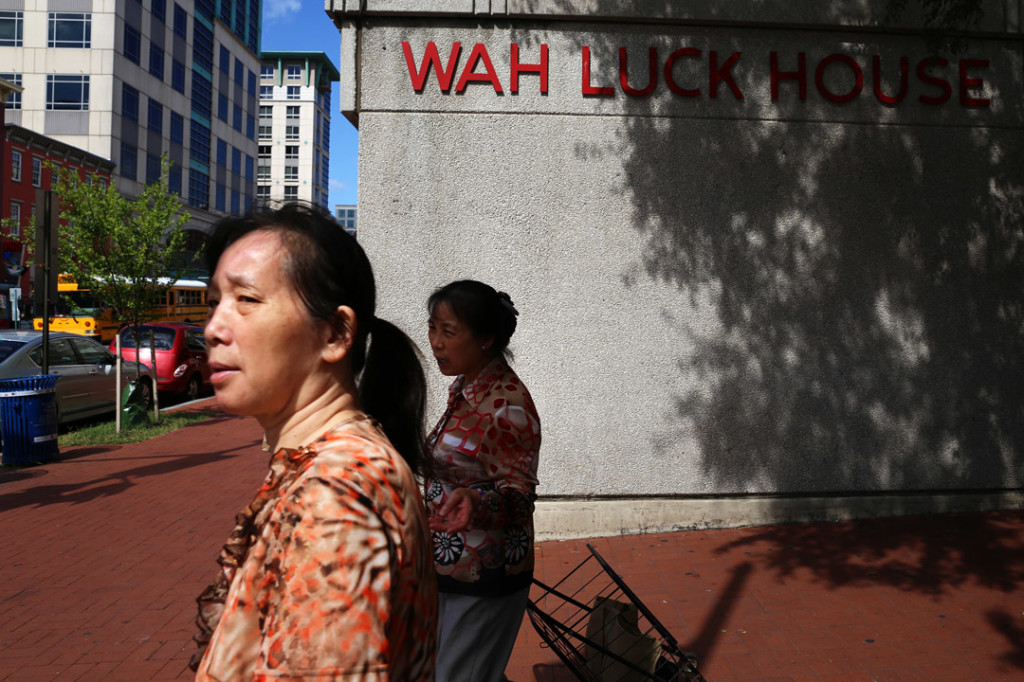 Two women walk past the Wah Luck House on Wednesday, August 13, 2014. The Wah Luck House apartments is home for a large number of elderly Chinese residents. Their lease is up for renewal in 2015 and may be sold for development. (Brian Nguyen/AAJA VOICES)