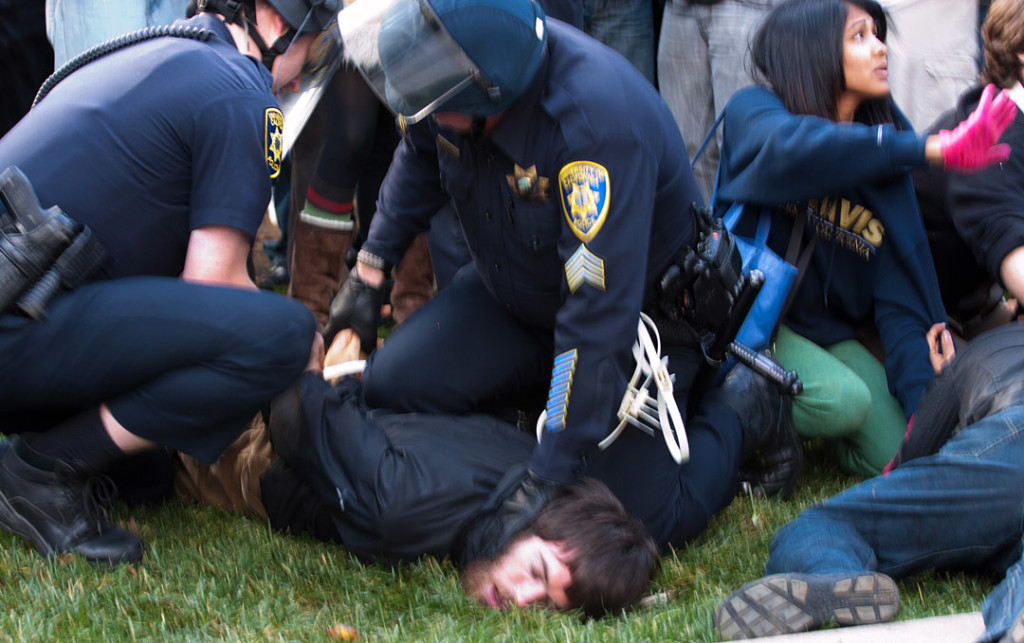 UC Davis police officers arrest a student during the raid on the Occupy UC Davis encampment on November 18, 2011 Davis, Calif. Shortly after, Lt. John Pike pepper sprayed the line of students (BRIAN NGUYEN/THE CALIFORNIA AGGIE)