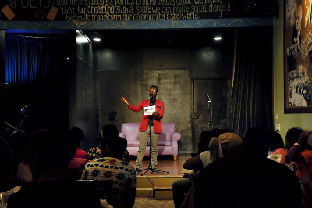 Host and poet Pages Matam opens the floor with an original poem at Open Mic night on Wednesday at BusBoys and Poets restaurant on 5th and K Street in Washington DC on Wednesday, August 13, 2014. (Sadia Khatri/AAJA VOICES)